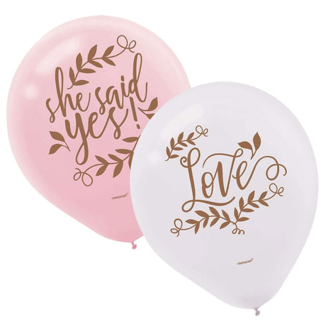Pink and white bridal shower balloons with gold script saying she said yes and love
