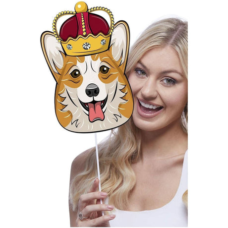 Woman holding a corgi dog face decoration with royal crown on stick from Fancy Dress Union Jack tableware props