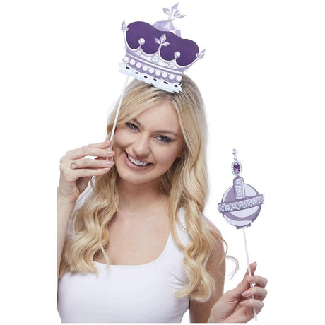 Woman holding Fancy Dress purple decorations props including a crown and orb with Union Jack tableware props theme