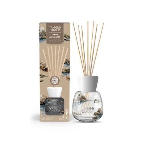 Yankee Candle amber and sandalwood reed diffuser with decorative rock design and natural reeds