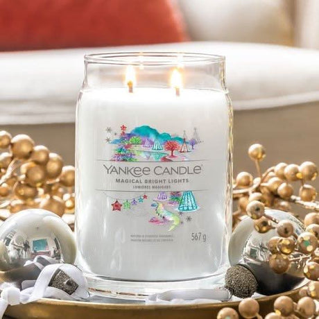 Yankee Candle Magical Bright Lights scented candle lit with two flames in clear glass jar