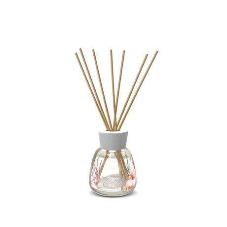 Yankee Candle Pink Sands reed diffuser with wooden sticks in clear glass bottle