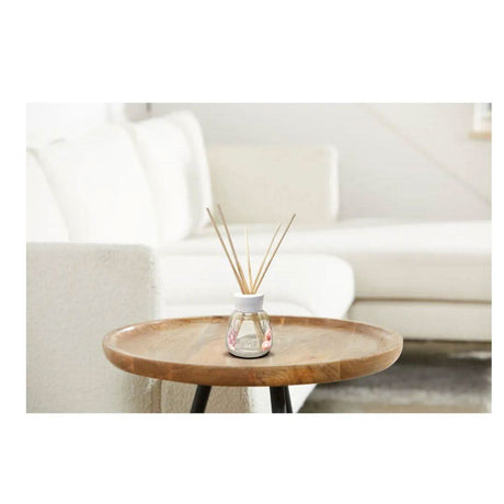 Yankee Candle Pink Sands reed diffuser on wooden table in modern white living room
