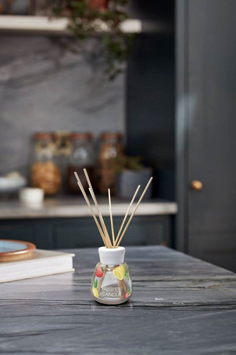 Yankee Candle reed diffuser with fruit design on marble kitchen countertop