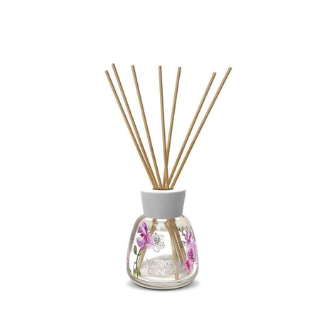 Yankee Candle wild orchid reed diffuser with floral design and natural reed sticks