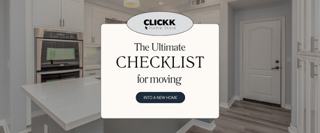 Modern kitchen with white cabinets and wooden floor featuring a moving into a new home checklist banner