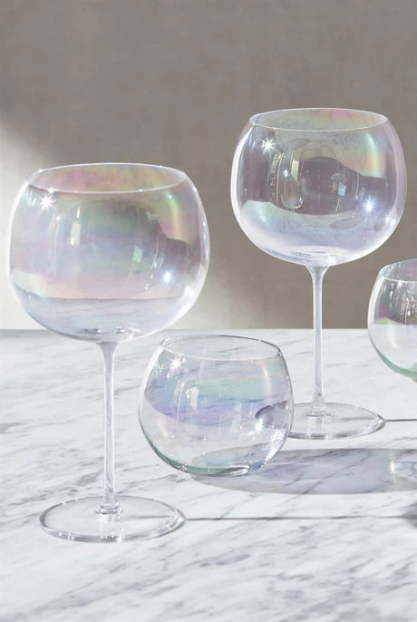 Elegant iridescent glassware set on marble surface showcasing summer homeware collection