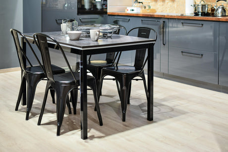 Modern kitchen setup with black metal chairs and table showcasing affordable kitchen appliances in sleek gray cabinetry