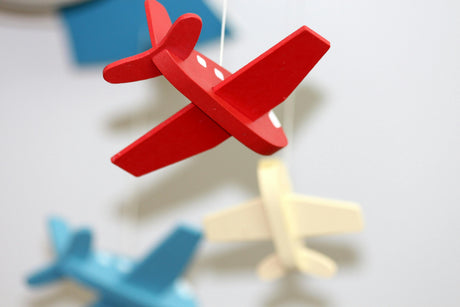 Colorful hanging mobile with wooden airplane