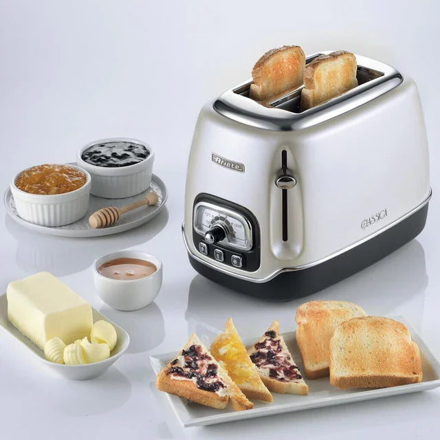 Best toasters for home use featuring a sleek stainless steel two-slot toaster with toasted bread and breakfast condiments