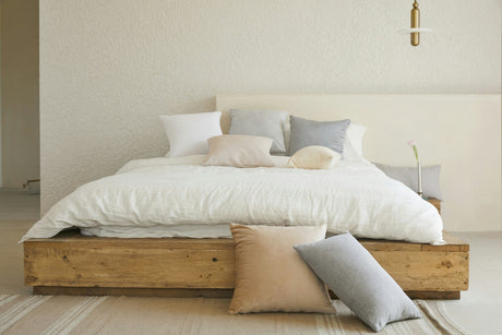 Affordable bedding sets with premium sheets, duvet covers, and pillows on a rustic wooden bed frame