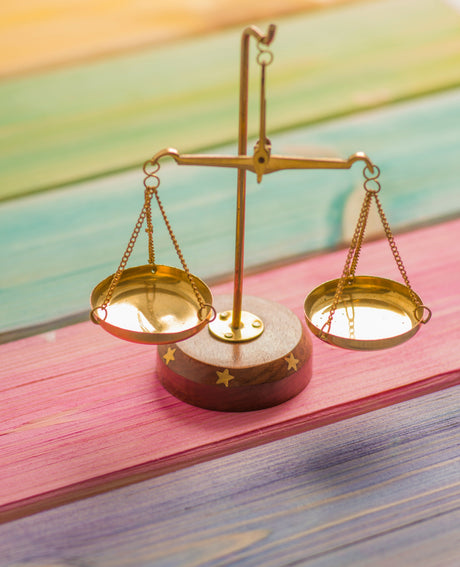 Vintage balance scale on colorful wooden surface representing precision of weight watchers bathroom scales