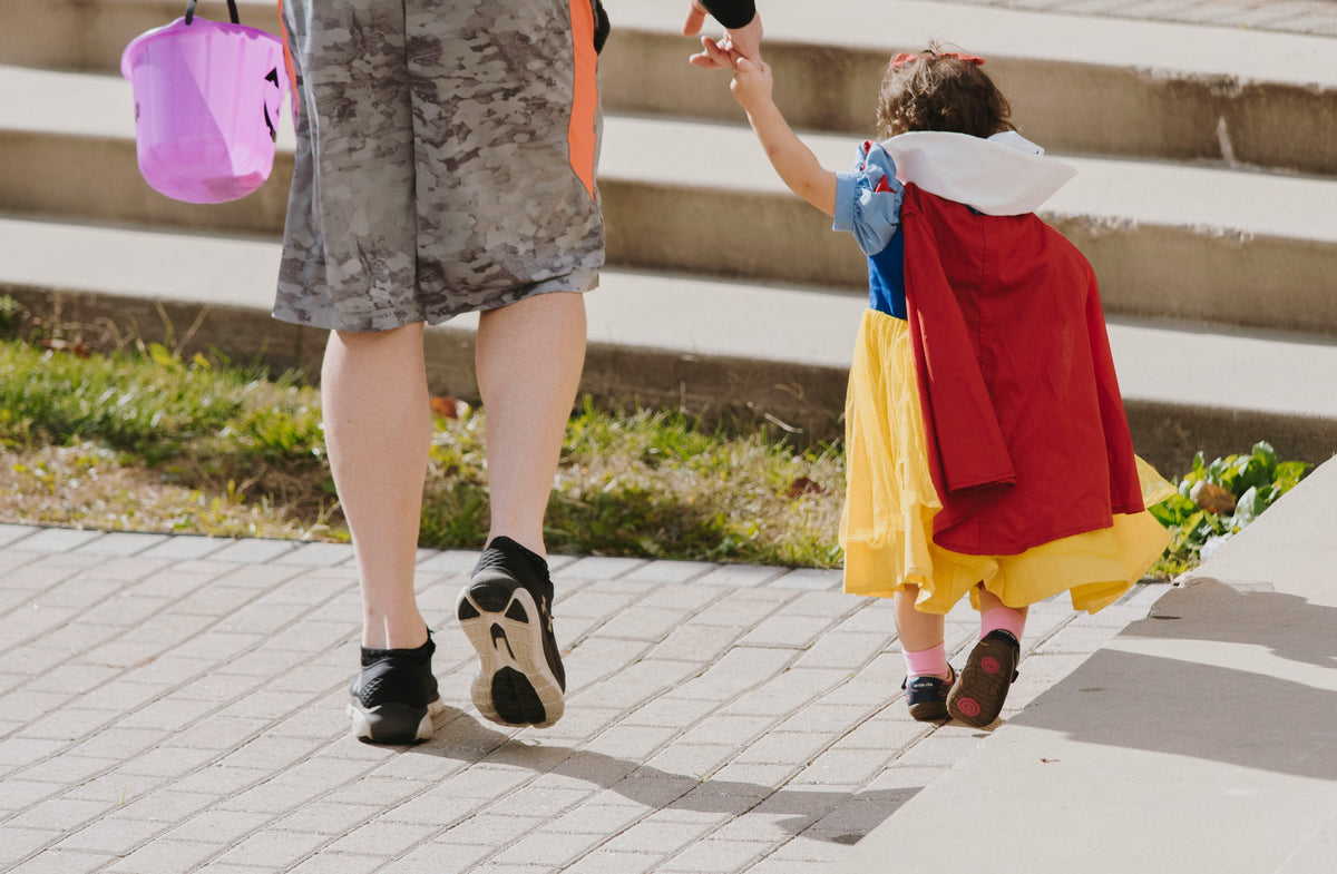Child in fairy tale costume holding hands with adult outdoors wearing kids accessories online