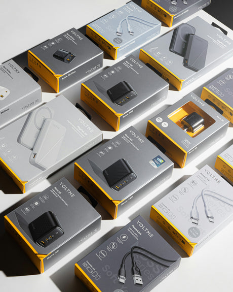 Fast car chargers for phones in sleek black and white packaging arranged on a surface