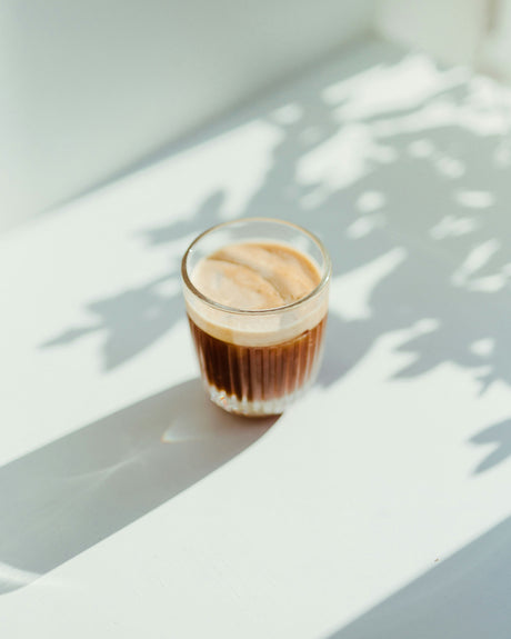 Close-up of a glass cup with fresh espresso shot highlighting Black Friday coffee machine deals