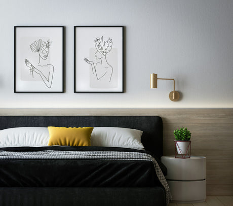 Minimalist bedroom with modern wall art and a small potted plant showcasing homeware under £10