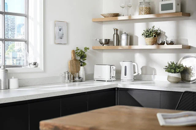 Modern kitchen featuring Kenwood kitchen appliances including a white toaster and electric kettle on a marble countertop