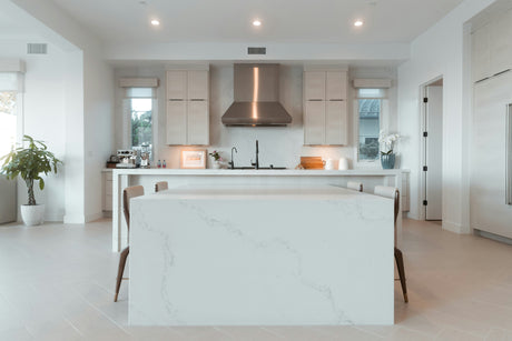 Modern white kitchen featuring Ariete kitchen appliances with sleek cabinetry and a large island