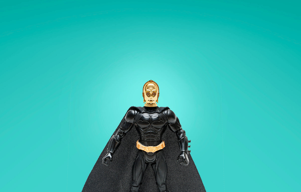 Black and gold themed men's fancy dress costumes featuring a superhero figure with a cape on teal background