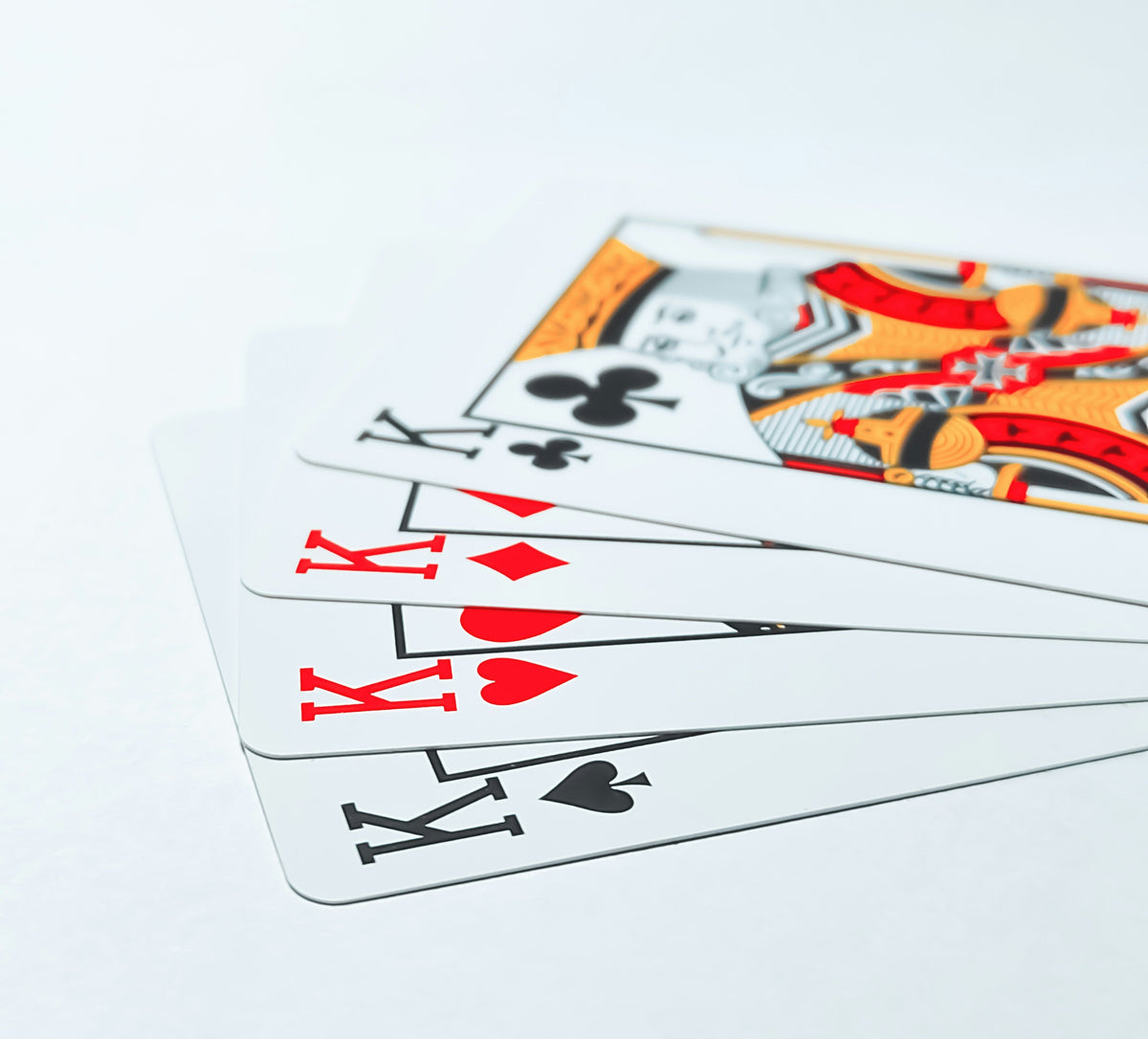 Close-up of playing cards featuring multiple kings showcasing unique collectibles for home