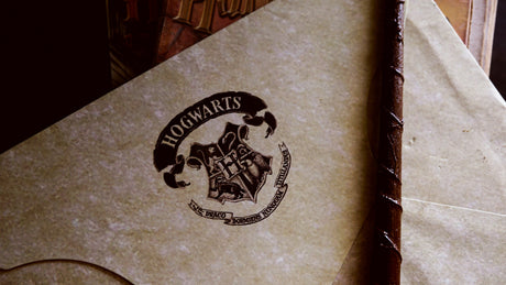 Harry Potter home decor featuring Hogwarts-themed parchment and a wizard wand accessory
