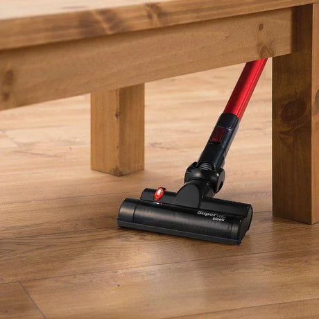 Cordless vacuum cleaner with red handle cleaning hardwood floor under wooden furniture vacuum cleaners for home use