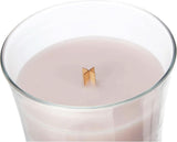 Large rosewood scented candle large in clear glass container with wooden wick burning softly