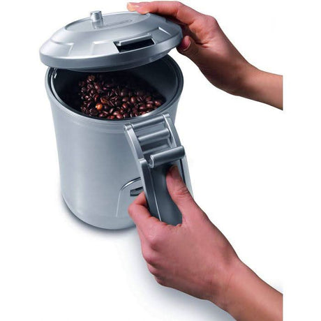 CLICKK Home Store stainless steel coffee canister being opened to reveal fresh coffee beans