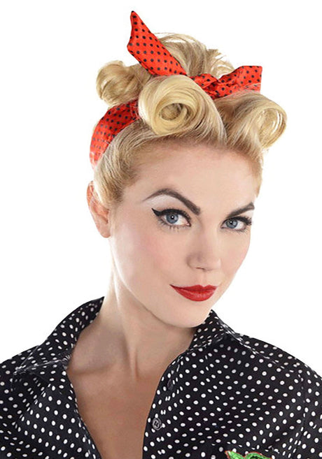 Blonde woman wearing a red polka dot 1960s rockabilly headscarf with vintage hairstyle and black polka dot blouse