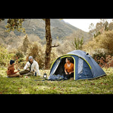 3 person dome tent set up in a scenic outdoor location with campers enjoying a relaxing afternoon