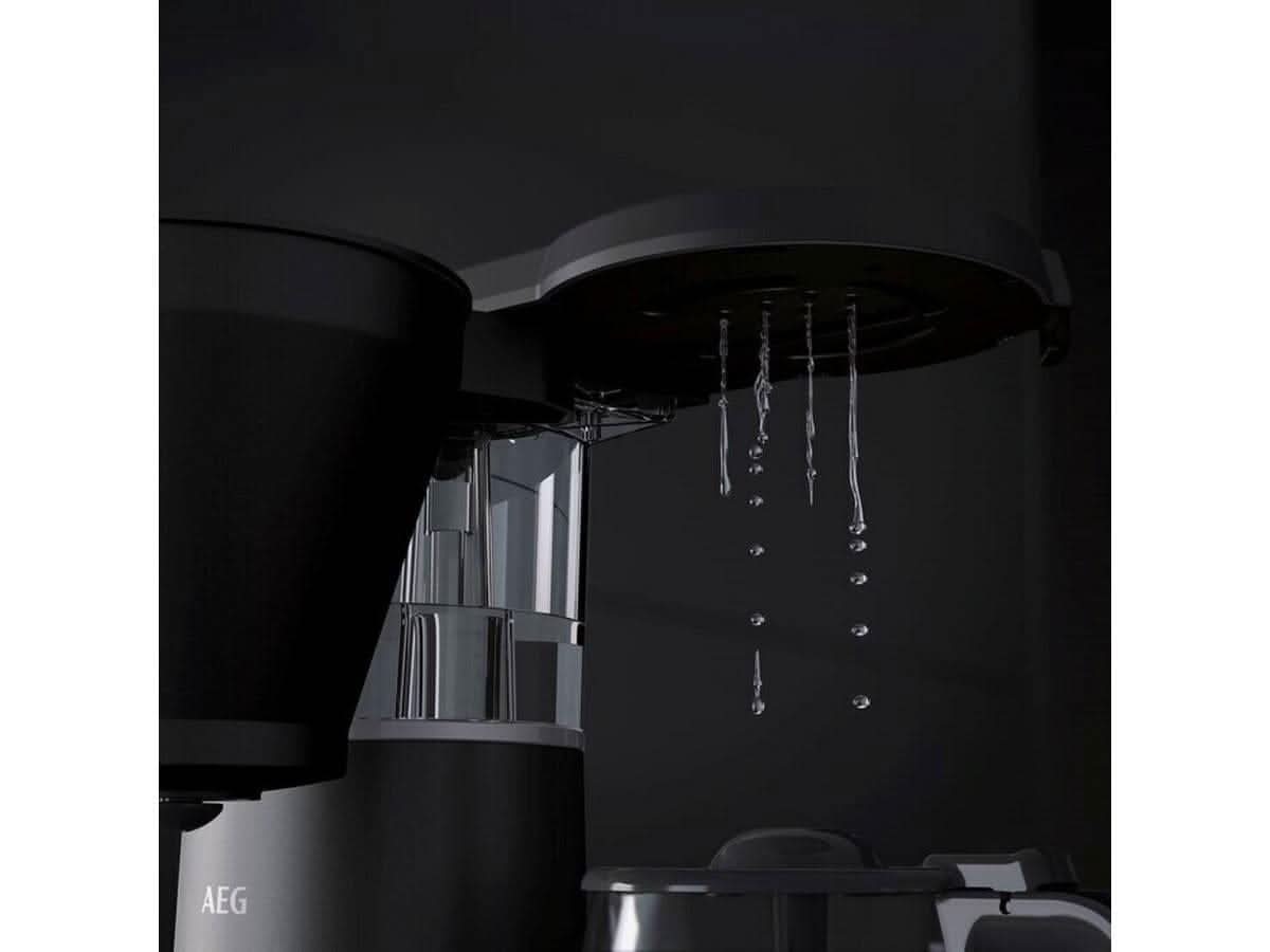 AEG coffee machine 1600W brewing fresh coffee with water droplets falling from the filter basket