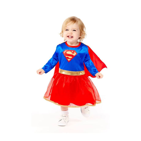 Toddler wearing a vibrant toddler supergirl costume with blue top, red cape, and red skirt