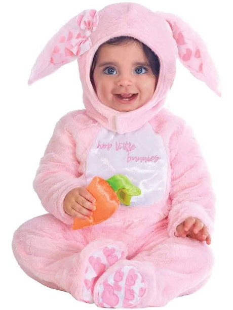 Infant wearing a pink baby bunny costume 3-6 months with floppy ears and carrot toy