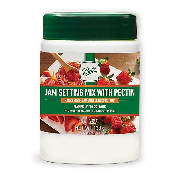 Ball jam setting mix with pectin in white container with green lid for making fresh strawberry jam