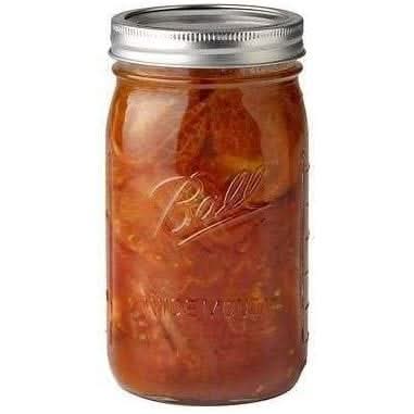 Ball wide mouth mason jars filled with homemade preserved fruit in a clear glass jar with silver lid
