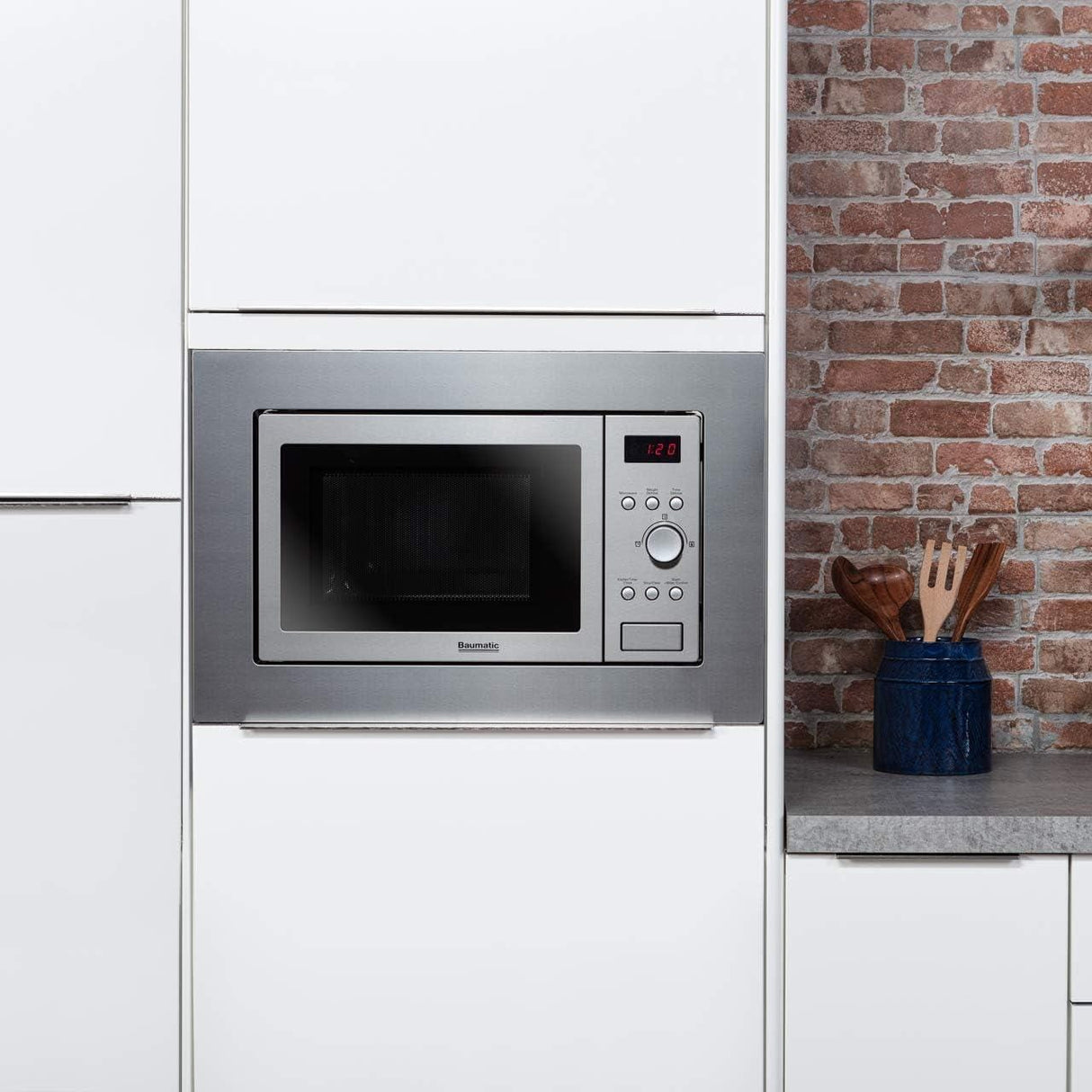 Hoover Baumatic built-in microwave with stainless steel finish integrated in modern white kitchen cabinetry