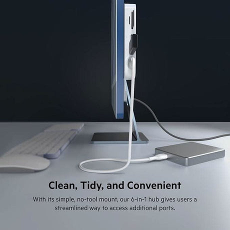 Belkin USB-C multiport hub mounted on a computer monitor with connected cables for added ports