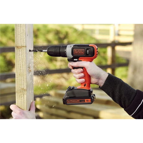 Black and Decker 18V drill driver being used to drill into wooden post outdoors