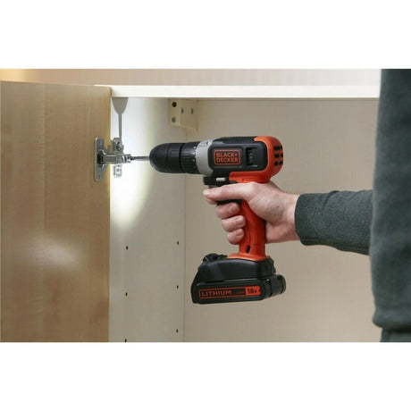 Black and Decker 18V drill driver being used to install cabinet hinge in a home improvement project