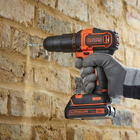 Black and Decker cordless drill set in use drilling into a brick wall with 18v lithium battery