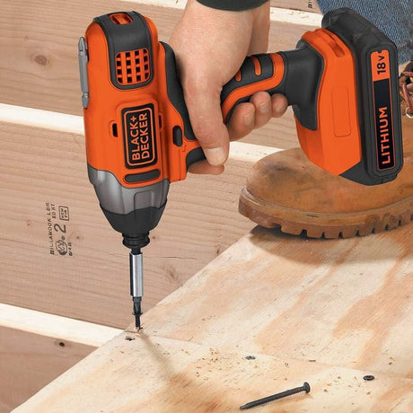 Black and Decker cordless drill set drilling into wood with 18V lithium battery in use