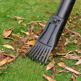 Black and Decker 3-in-1 blower vacuum attachment with rake on green grass and fallen leaves