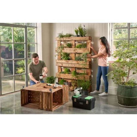 Black & Decker toolbox 19 inch next to a couple assembling a wooden planter indoors