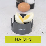 Calitek 3-in-1 egg cutter slicing a boiled egg into halves on white surface