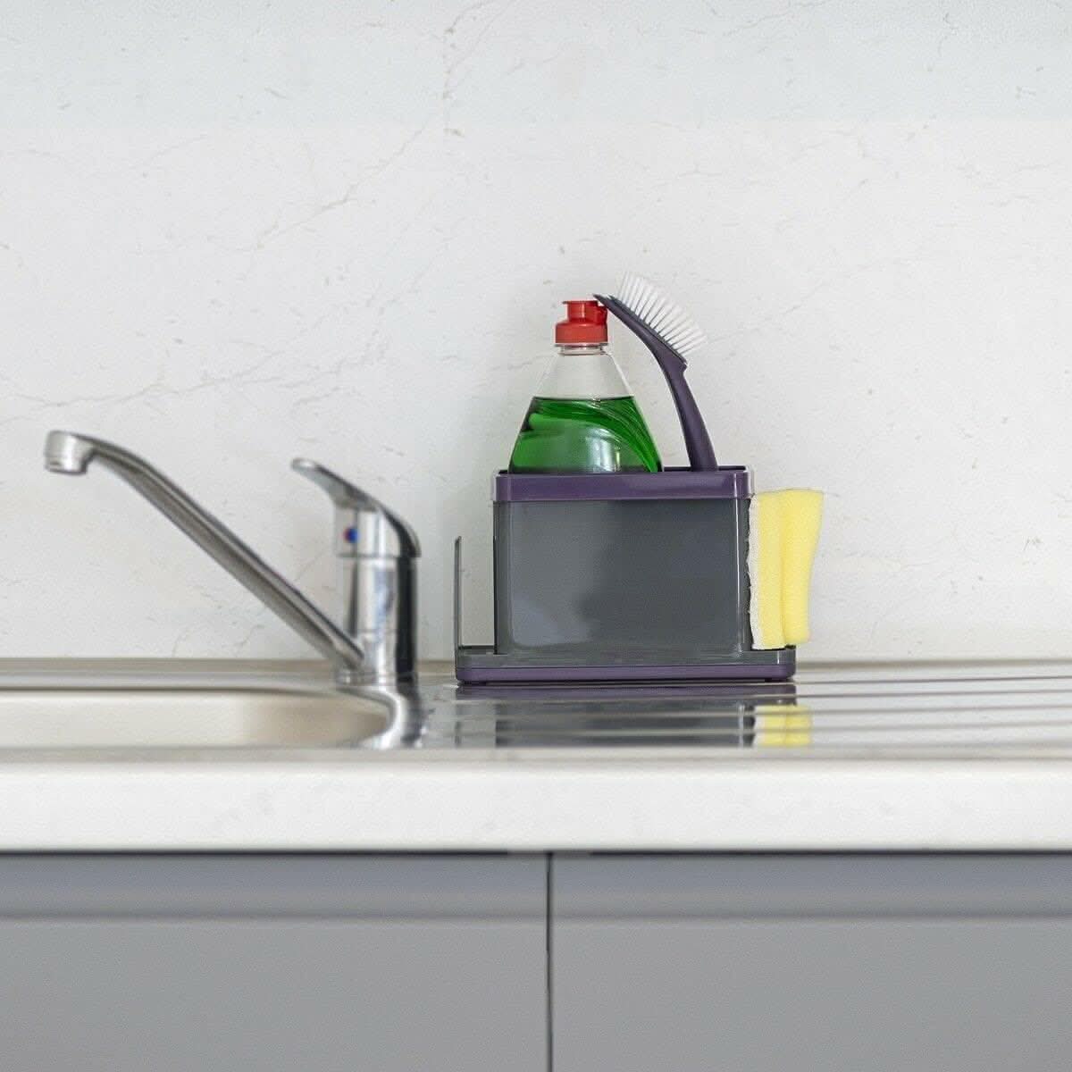 Calitek purple sink caddy organizer holding a dish brush, sponge, and dish soap bottle on kitchen countertop