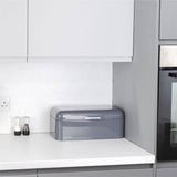 Calitek retro steel bread bin in gray on white kitchen countertop with modern cabinets