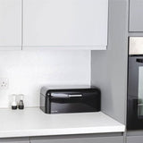 Calitek black retro style bread bin on white kitchen countertop with salt and pepper shakers