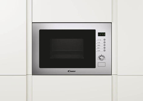 Candy built-in microwave with grill in stainless steel integrated into white kitchen cabinetry