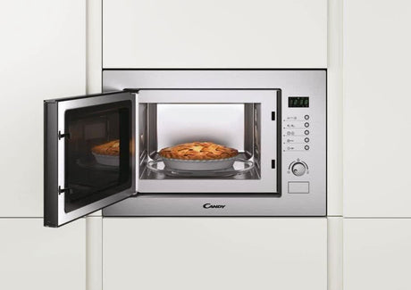 Built-in microwave with grill in stainless steel from CLICKK Home Store with open door and pie inside