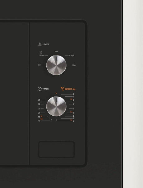 Close-up of control panel with dials on Candy built-in microwave 1000W in black finish